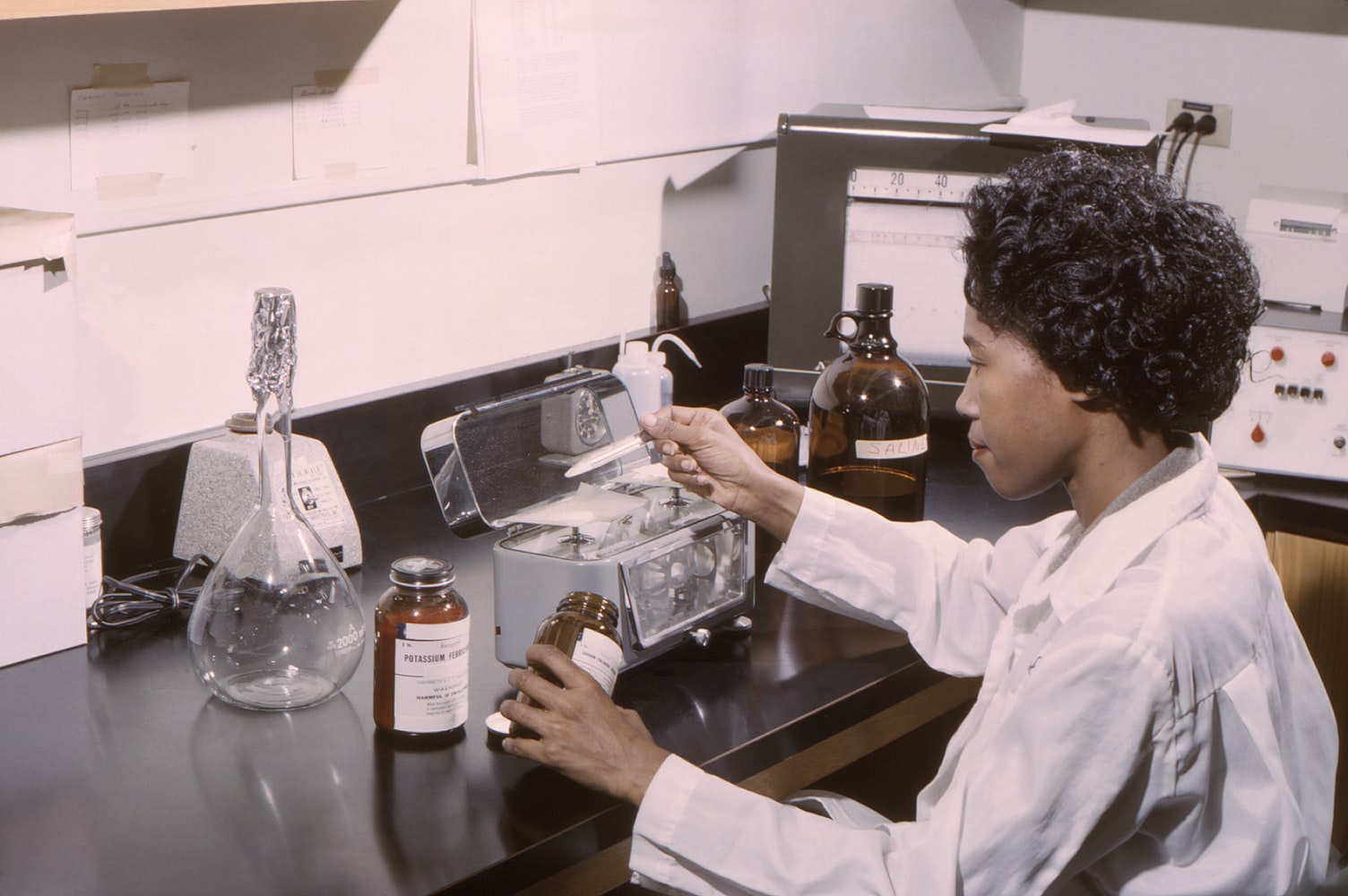 Inspector using a mobile device to inspect chemical storage containers in an industrial facility
