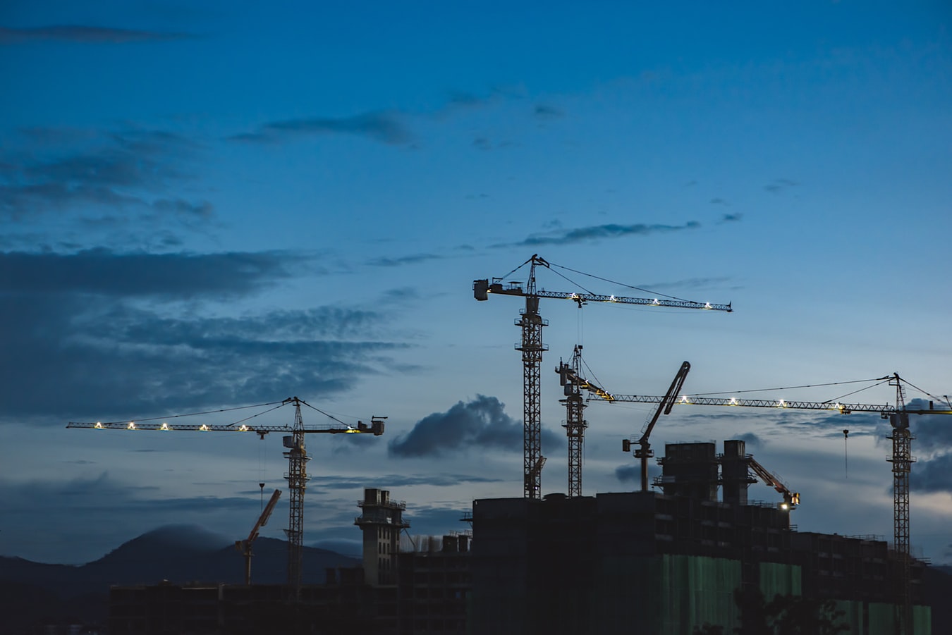 Crane and lifting equipment inspector conducting a digital pre-use safety check on a construction site