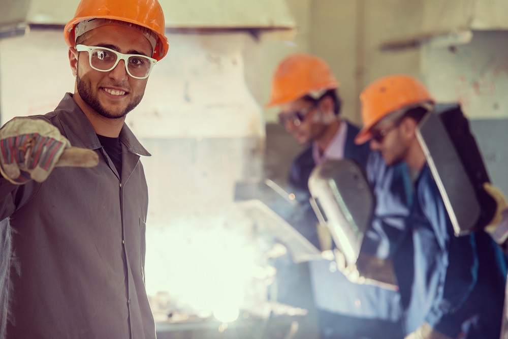 Quality control inspector checking structural steel welds against AS 4100 requirements using a digital inspection checklist