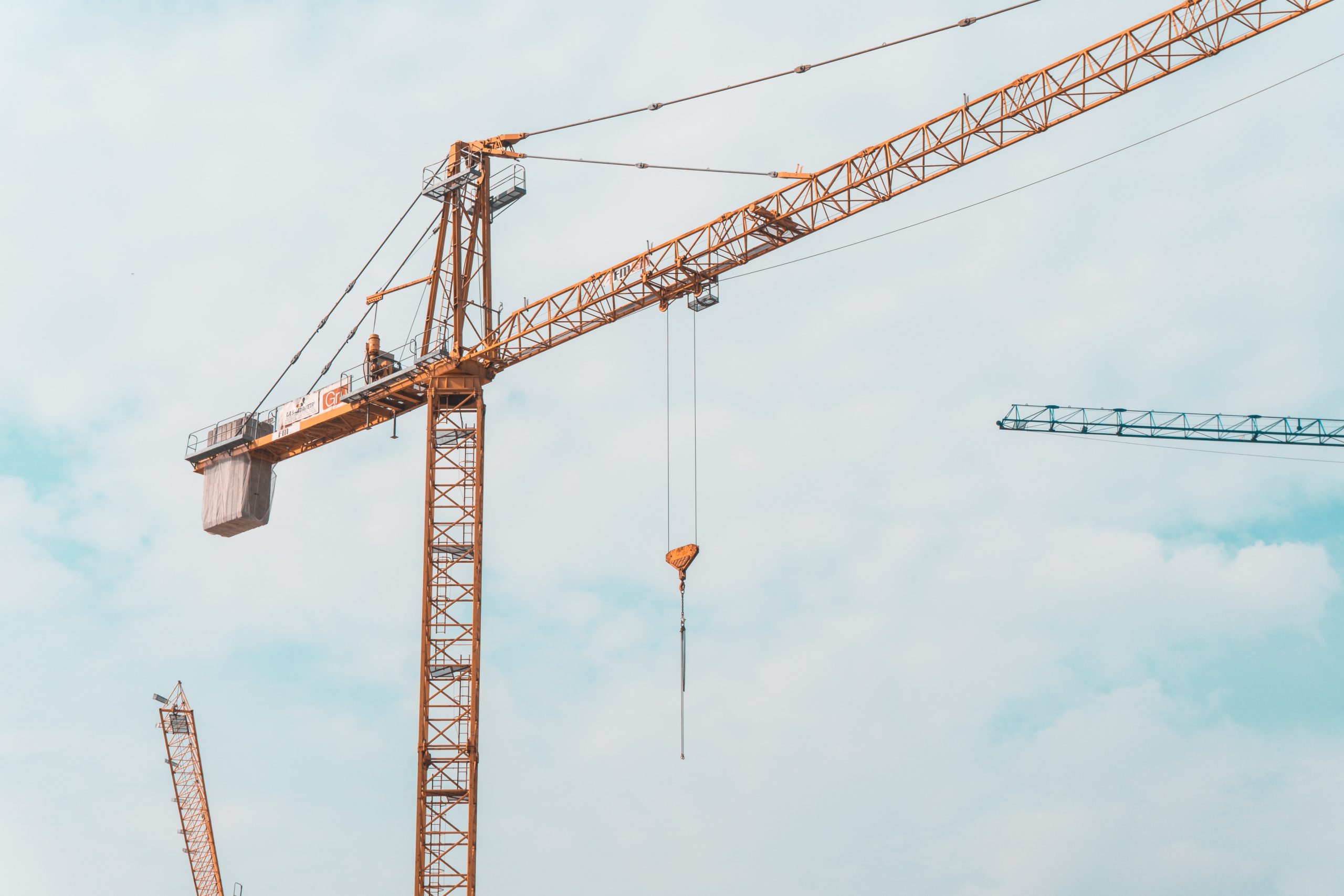 Inspector using a mobile device to complete a digital lifting equipment inspection checklist