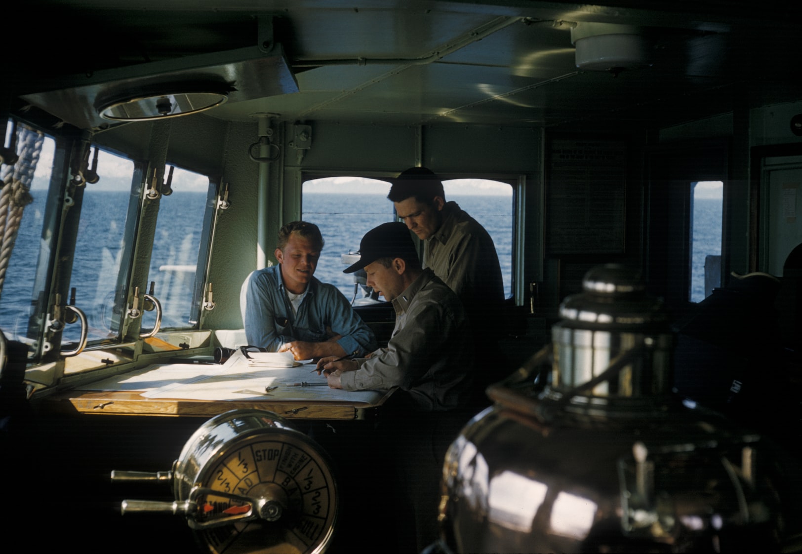 Marine inspector using a tablet to complete a digital vessel inspection checklist on board