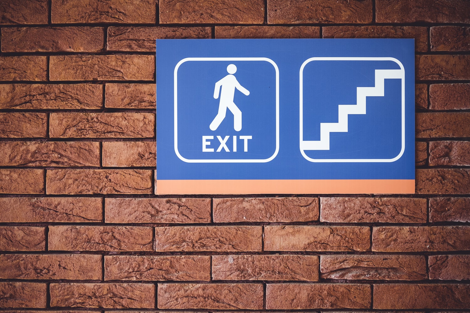 ISO 7010 compliant safety signs displayed in a workplace corridor